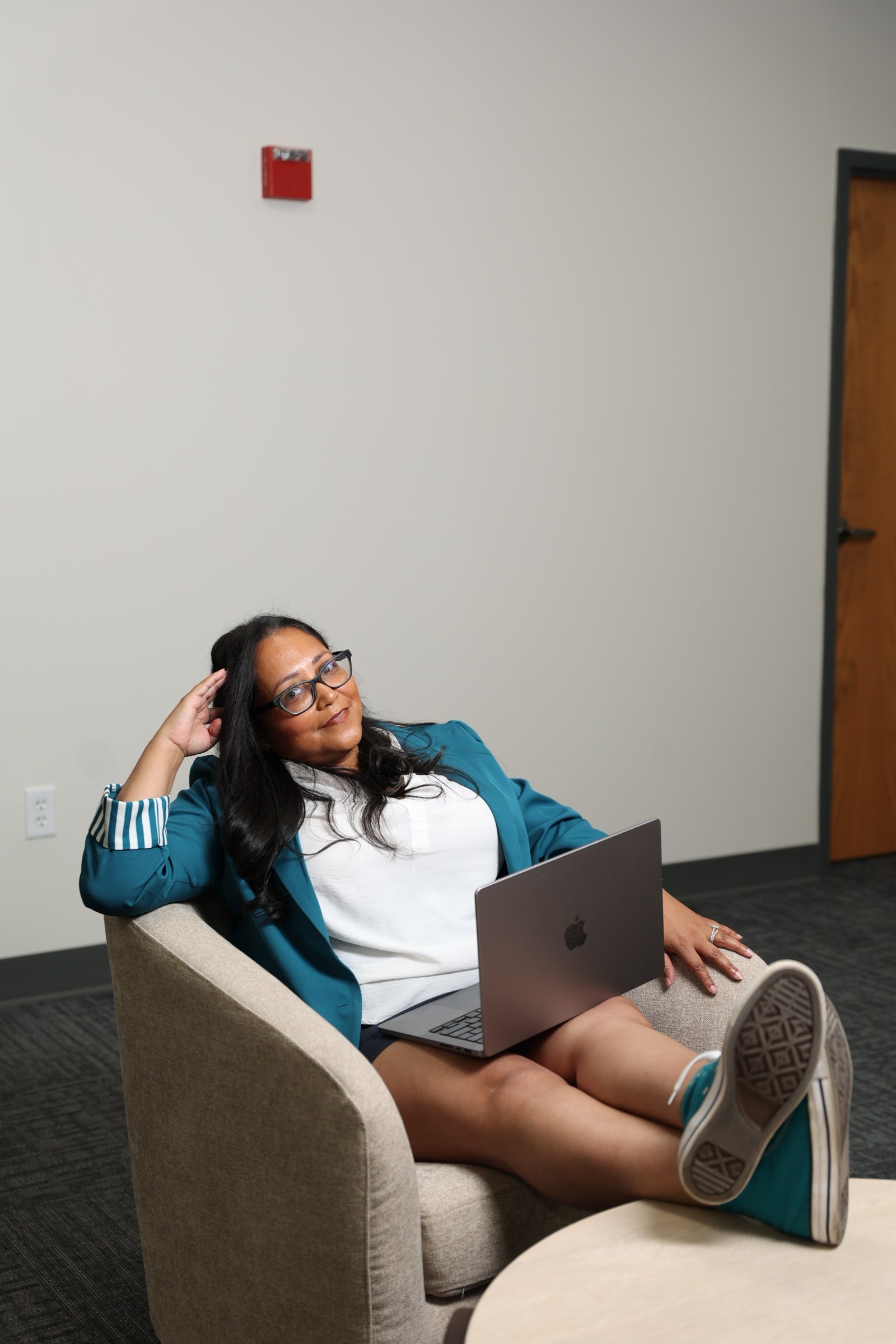 Damaris Rodriguez reviewing new listings on her laptop